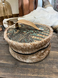The Patina Cowhide Round Toiletry Bag